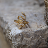 Gold ring with coiled snake and zircons