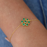 Gold bracelet and stone flower