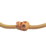 Bracelet cordon doré tête de mort beige