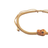 Bracelet cordon doré tête de mort beige