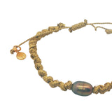 Bracelet cordon doré et perle de culture grise