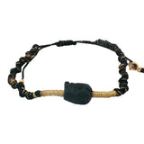Bracelet doré cordon tressé noir et doré avec tête de mort noire