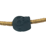 Black cord bracelet, gold and black skull