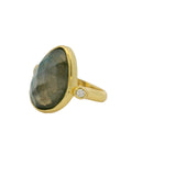 Gold ring with XXL faceted stone and zircons