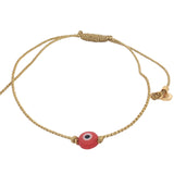 Bracelet doré sur fil fin avec oeil plat rouge