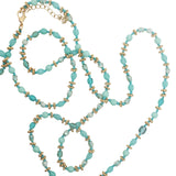 Collier doré perles turquoises et vert d'eau, couronnes dorées et noeuds turquoises 75 cm