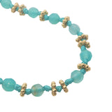 Collier doré perles turquoises, couronnes dorées et noeuds turquoises 75cm