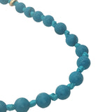 Collier doré perles turquoise, disques dorés et noeuds turquoise 42 cm