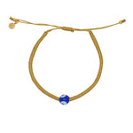 Bracelet tressé doré et oeil en verre