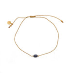 Bracelet tressé doré et perle grise