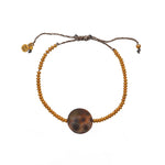 Bracelet cordon disques dorés et coquillage