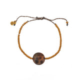 Bracelet cordon disques dorés et coquillage