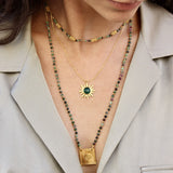 Collier doré soleil et pierre cabochon