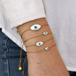 Bracelet tressé doré et coeur oeil nacre