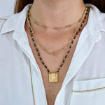 Collier cordon doré pierres et plaque soleil