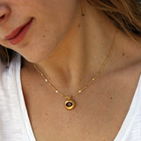 Collier doré coeur et oeil en verre bordeaux