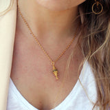Collier doré talisman zircons