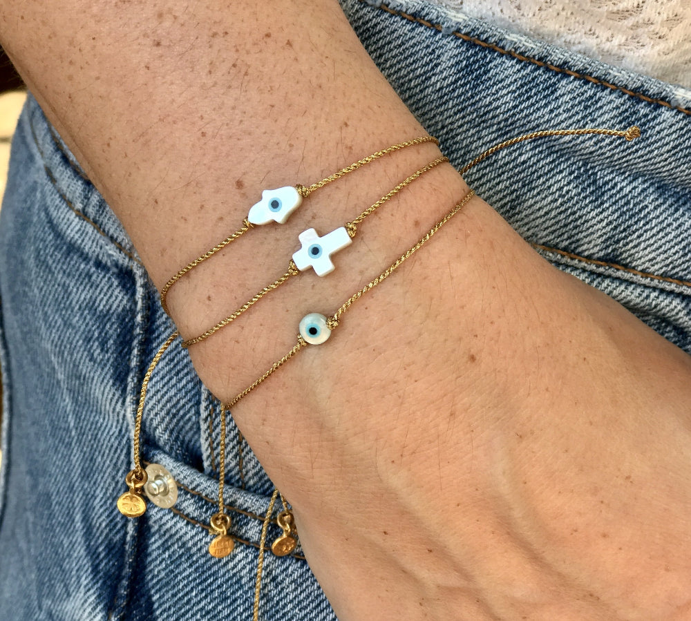 Bracelet tressé doré et croix avec oeil