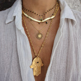 Gold necklace with openwork eye medal and zircons