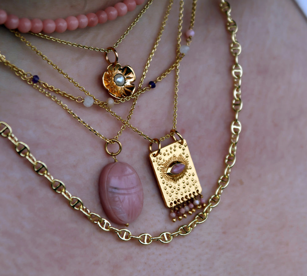 Gold necklace with flower and stone pendant