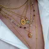 Gold necklace with cabochon stone and star pendant