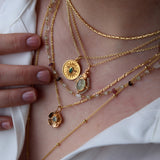 Gold necklace with cabochon stone and star pendant