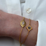 Bracelet doré oeil strié et pierre