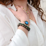Gold cord bracelet with faceted stone
