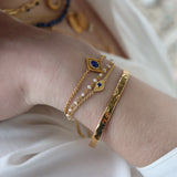 Small eye and stone gold bracelet