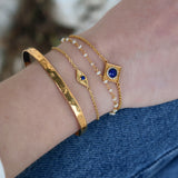 Small eye and stone gold bracelet