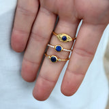 Golden ring with round stone and zircons