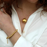Gold necklace and brushed ball