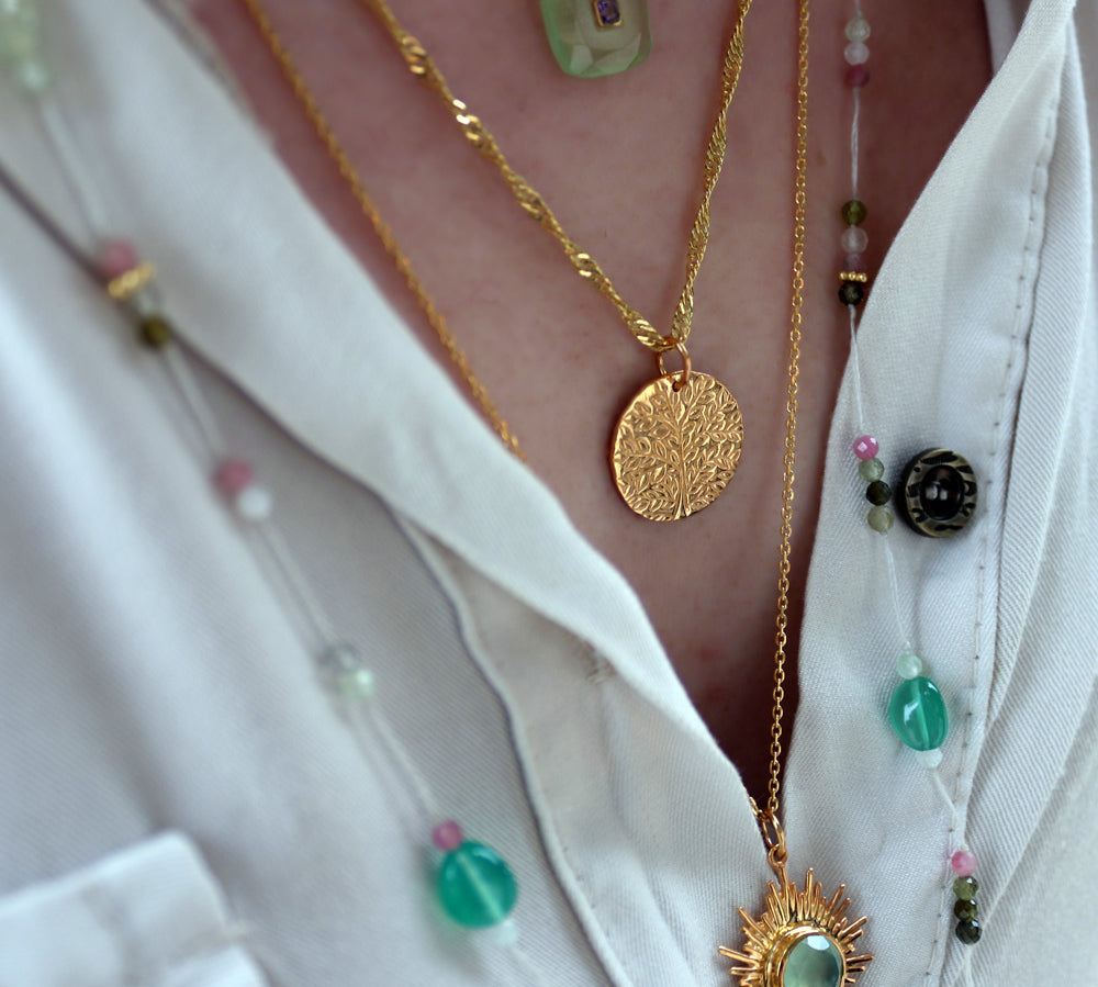 Gold necklace and engraved tree of life medal