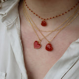 Golden necklace with large heart stone pendant