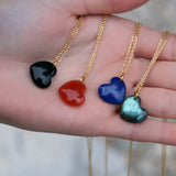 Golden necklace with large heart stone pendant