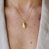 Gold open hand and zircon necklace