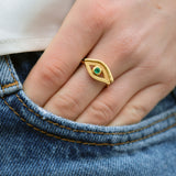 Gold ring with textured eye and stone