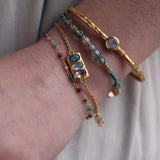Hammered rectangle gold bracelet and trilogy of stones