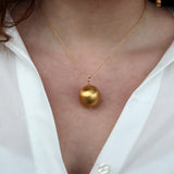 Gold necklace and brushed ball