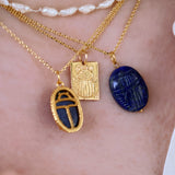 Gold necklace with engraved scarab and "lucky" pendant